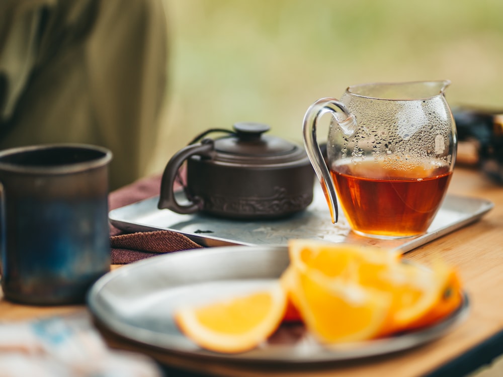 a pitcher of tea sitting on top of a wooden table