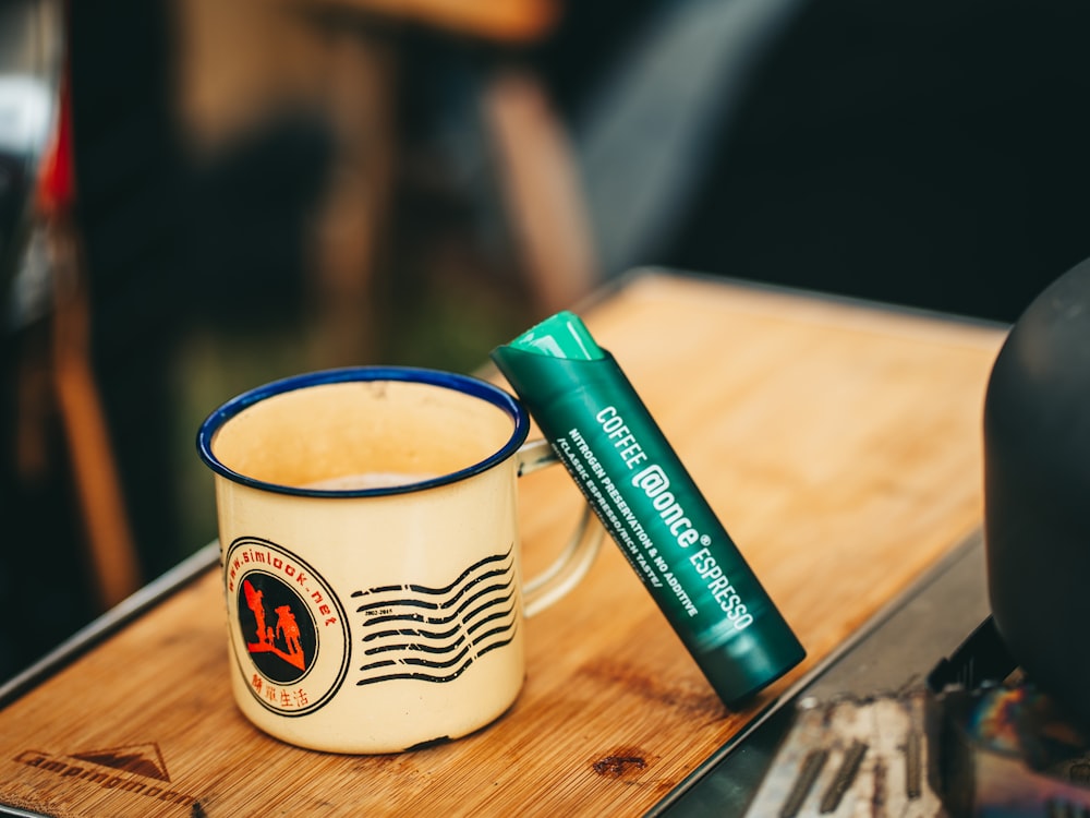 a cup of coffee sitting on top of a wooden table