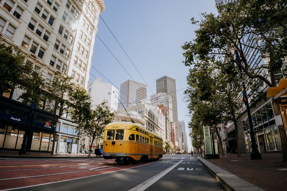 a yellow bus is driving down the street