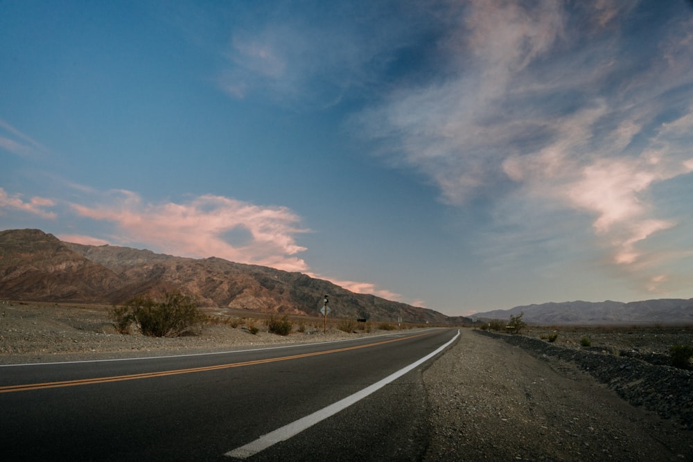 a road with a mountain in the background