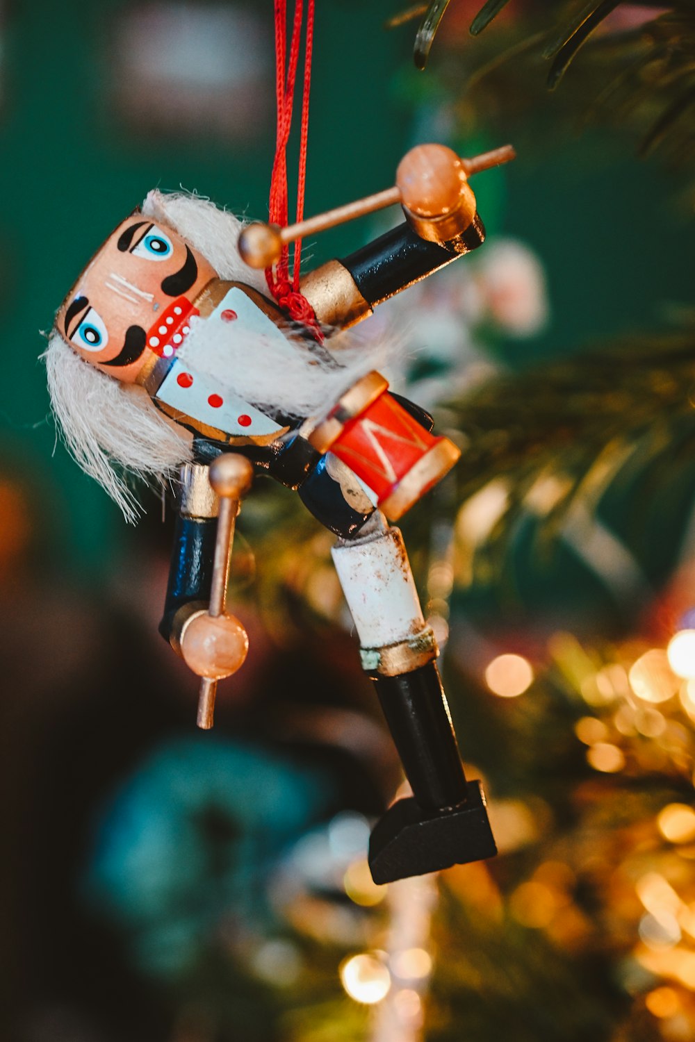 a nutcracker ornament hanging from a christmas tree