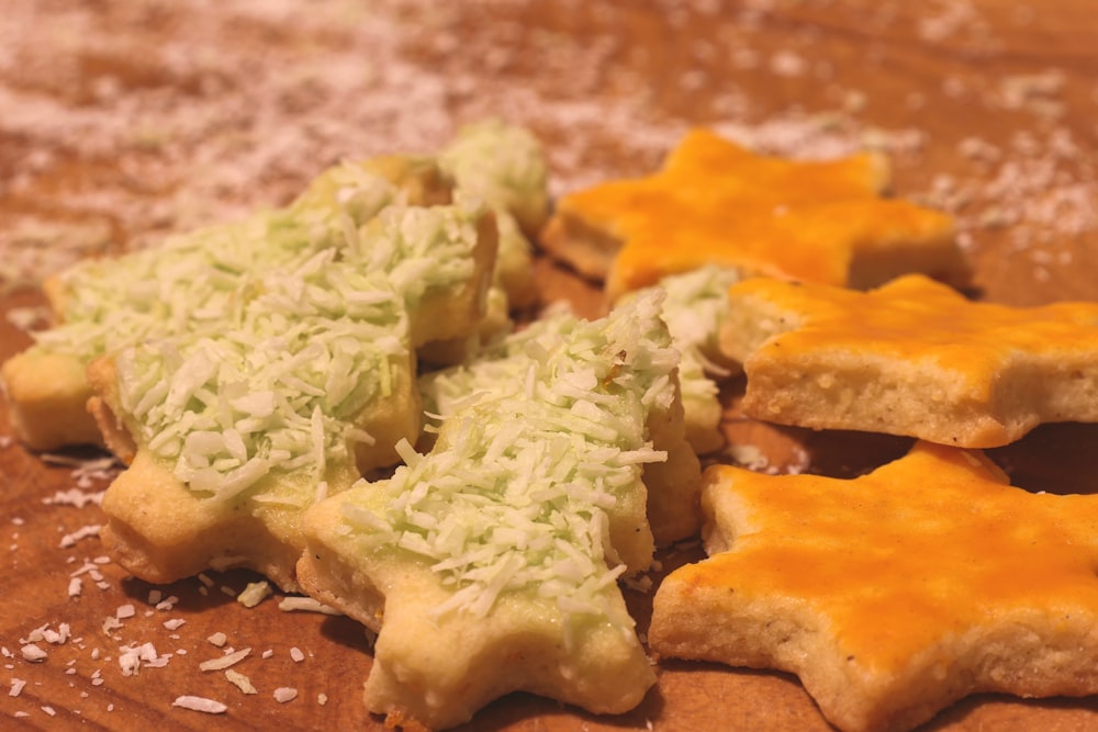 a wooden cutting board topped with cut up cookies