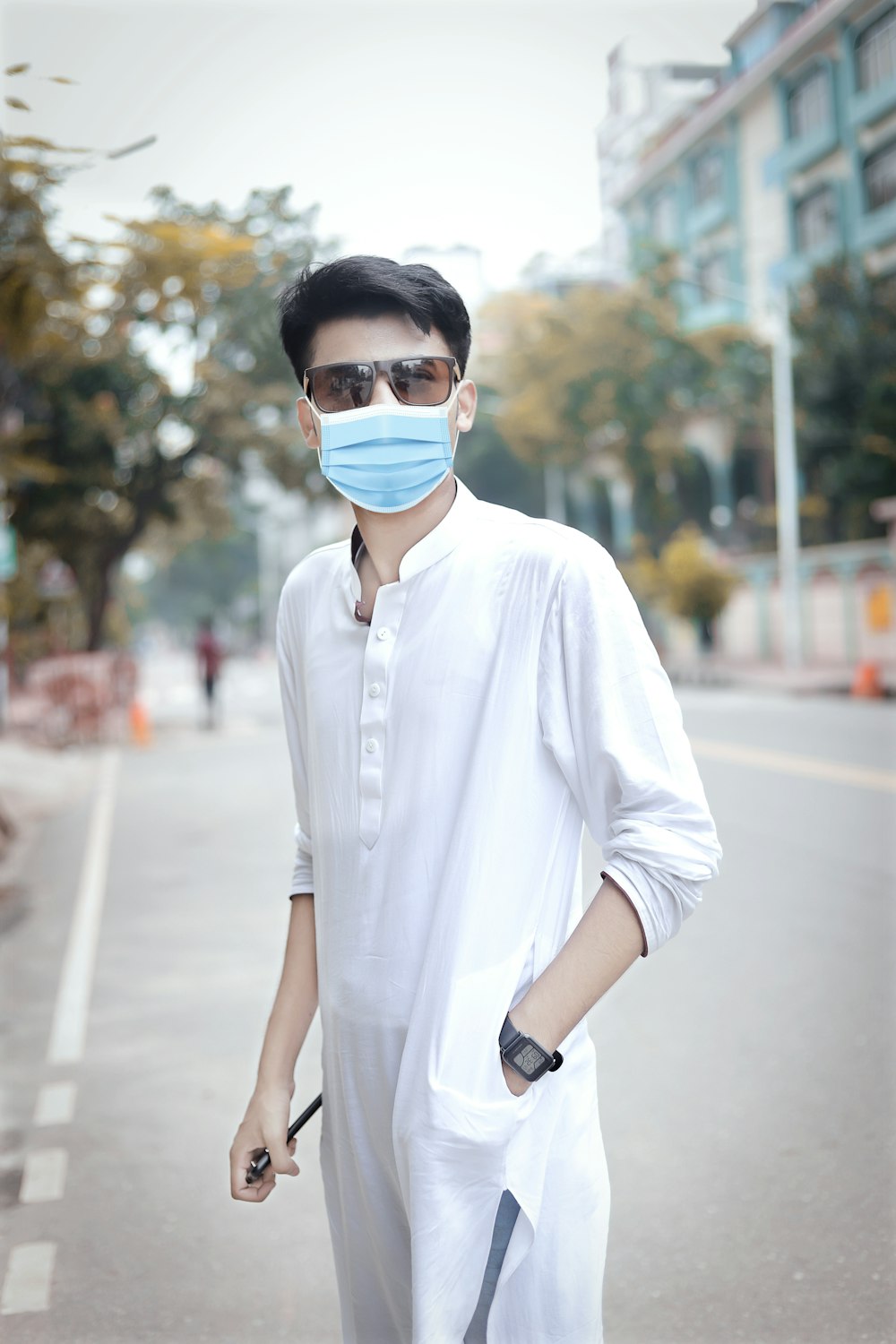 a man wearing a face mask while walking down a street