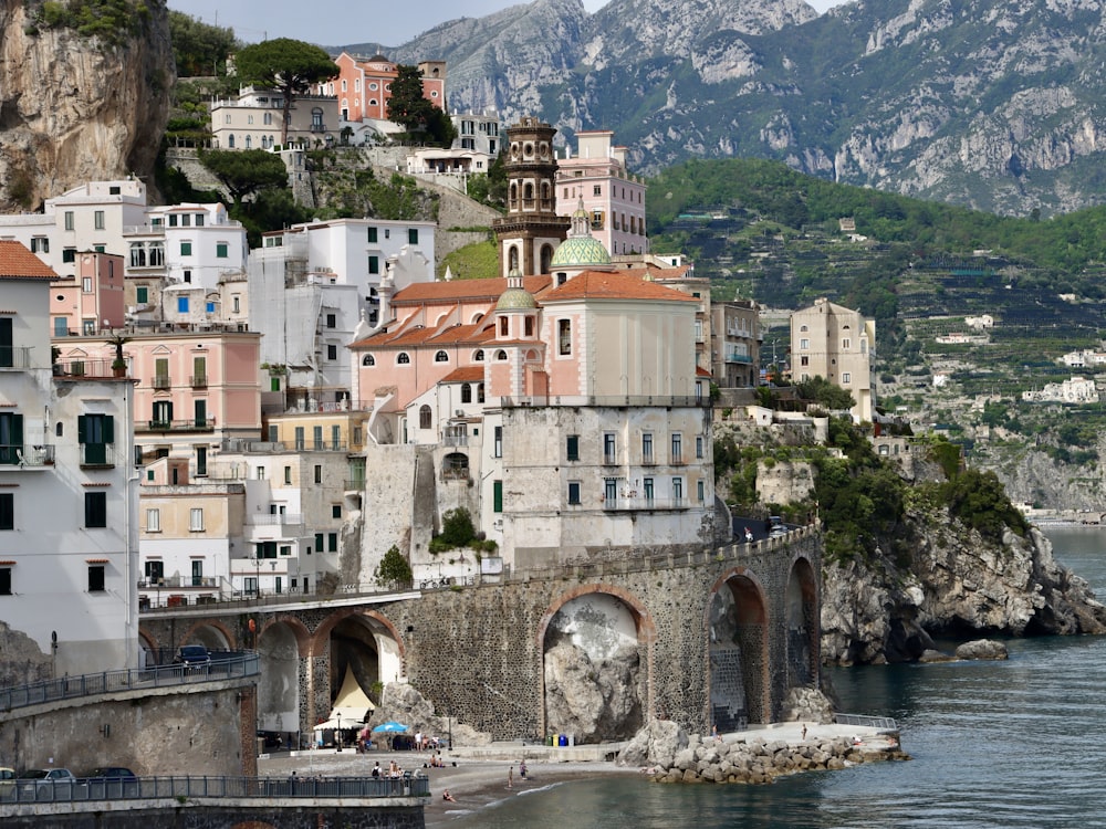 a view of a town on the shore of a body of water