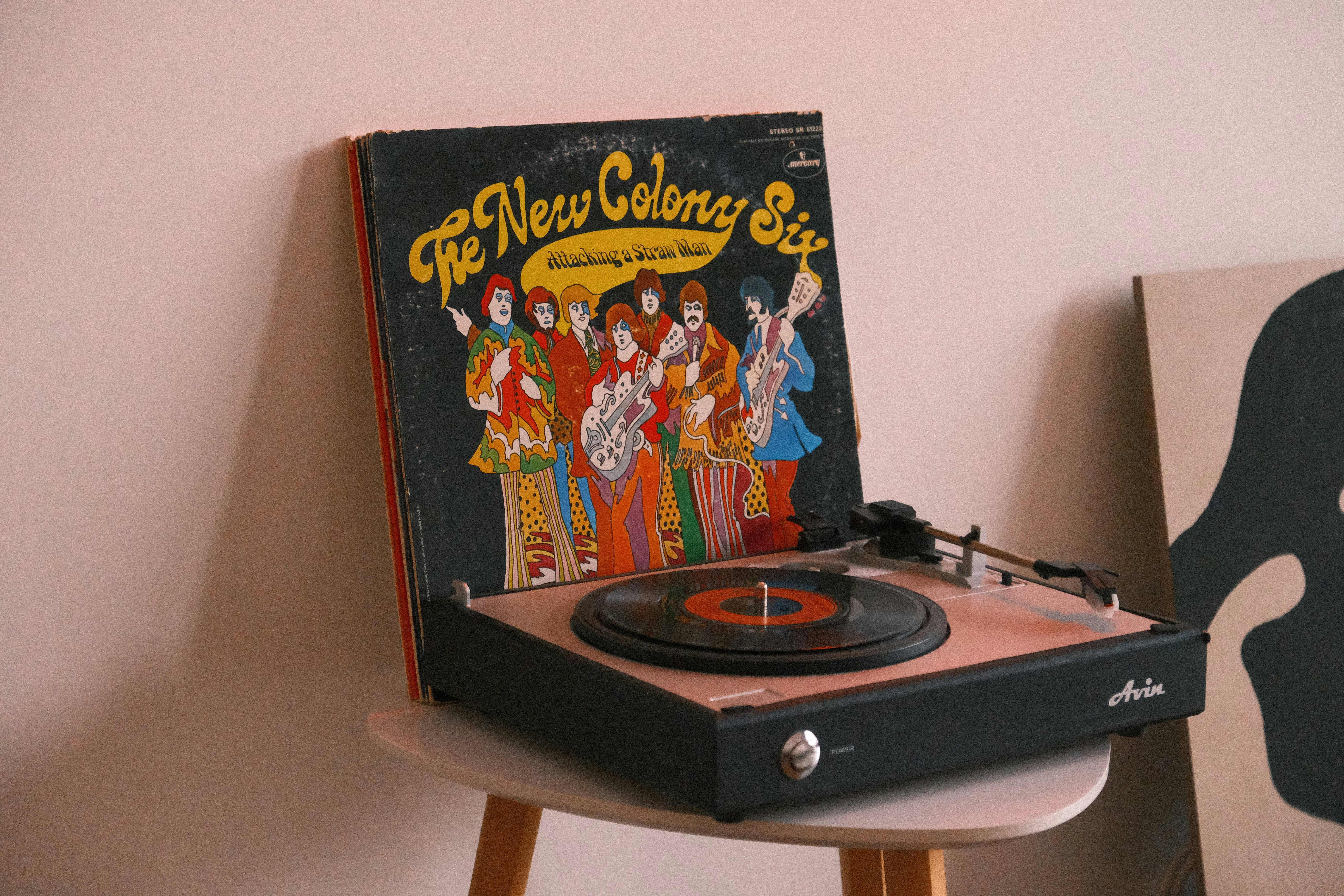 a record player sitting on top of a wooden table