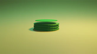 Steel plates neatly stacked with a subtle shadow on a green background