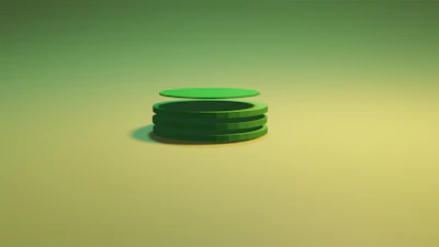 Steel plates neatly stacked with a subtle shadow on a green background