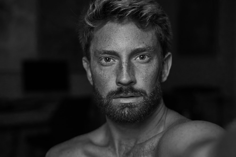 a black and white photo of a shirtless man