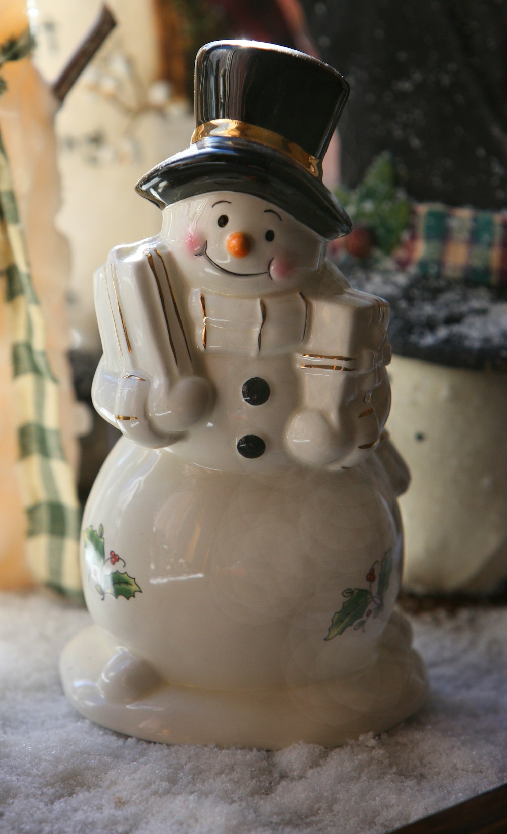 a white snowman with a top hat and scarf