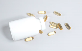 Close-up of Neo Force capsules spilling out of a sleek, modern bottle on a wooden surface