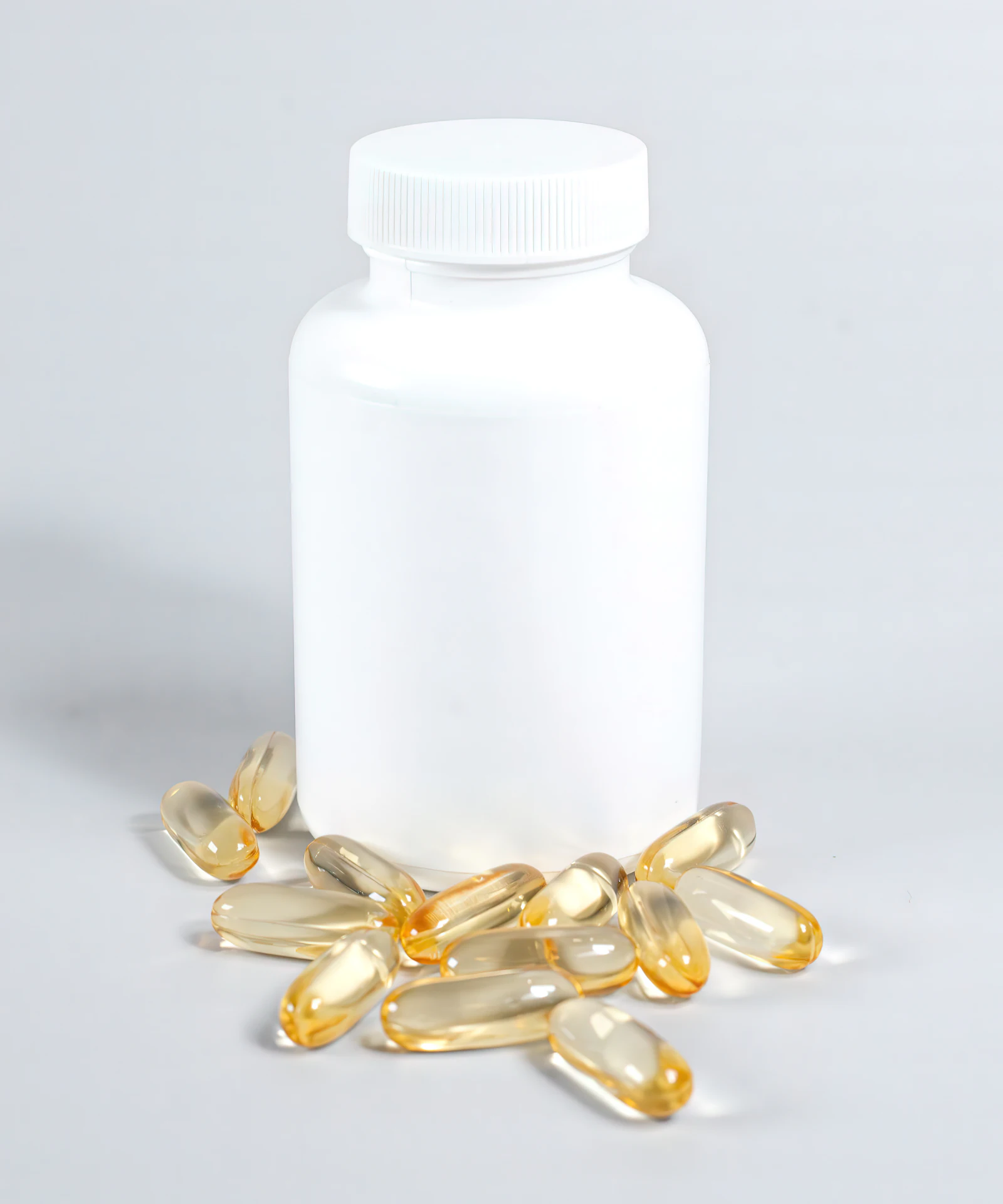A bottle of fish oil capsules spilling out