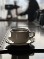 A quiet moment of reflection as a team member reviews reports with a cup of coffee nearby.