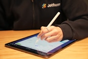 A digital document being signed on a tablet or laptop, showing a handwritten signature