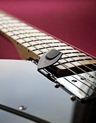 a close up of an electric guitar with a pick