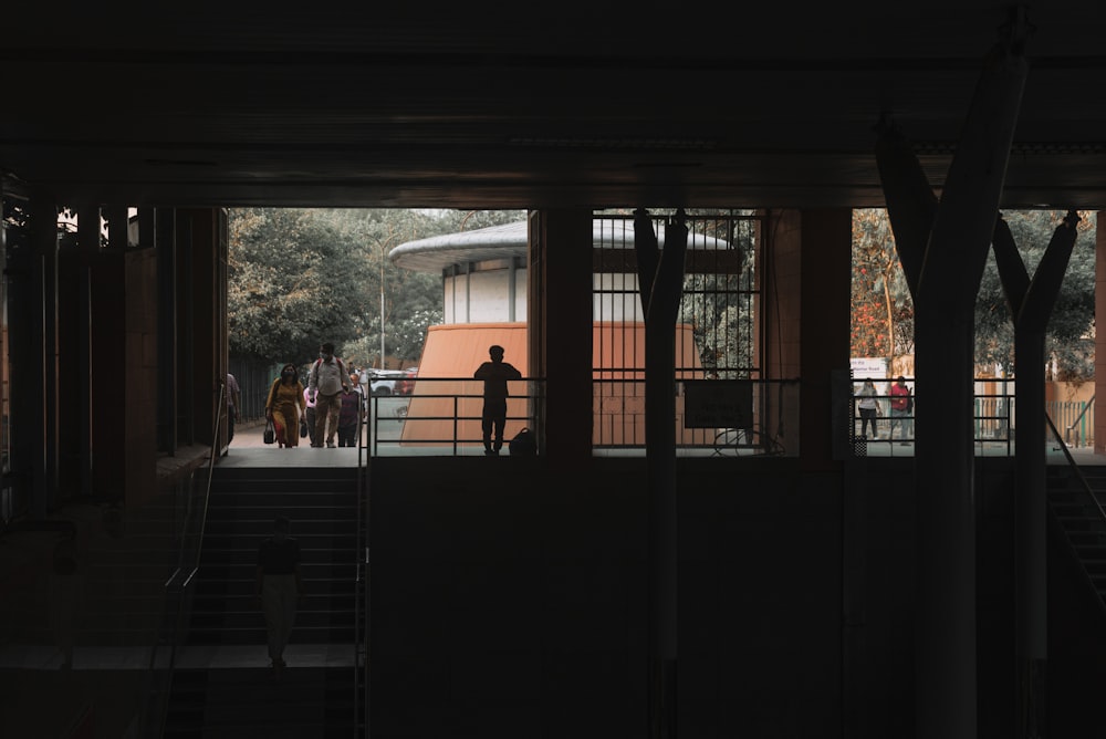 a group of people walking down a dark hallway