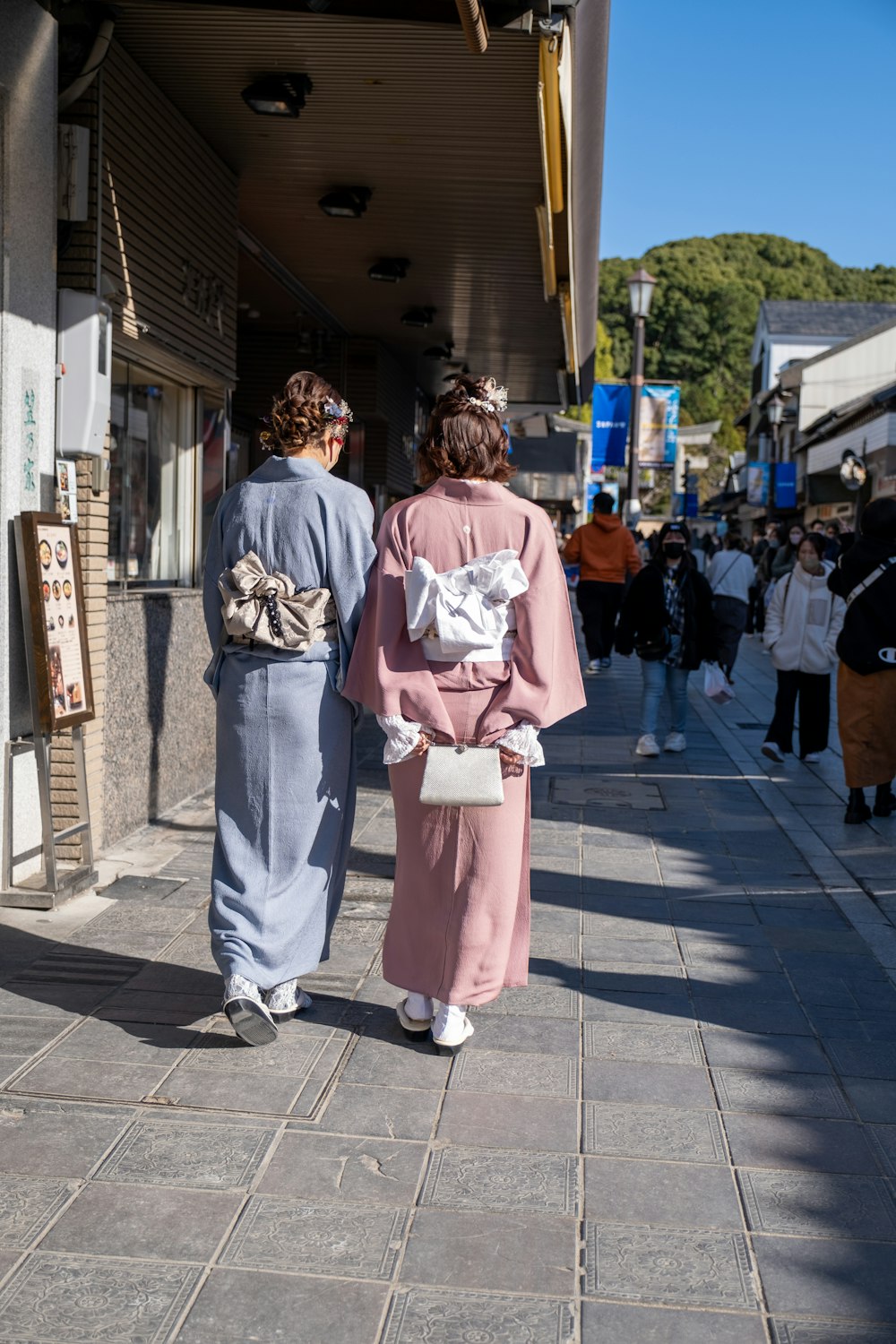 a couple of people that are walking down a street