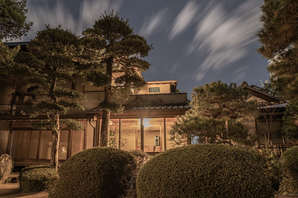 a house is lit up at night with a sky background