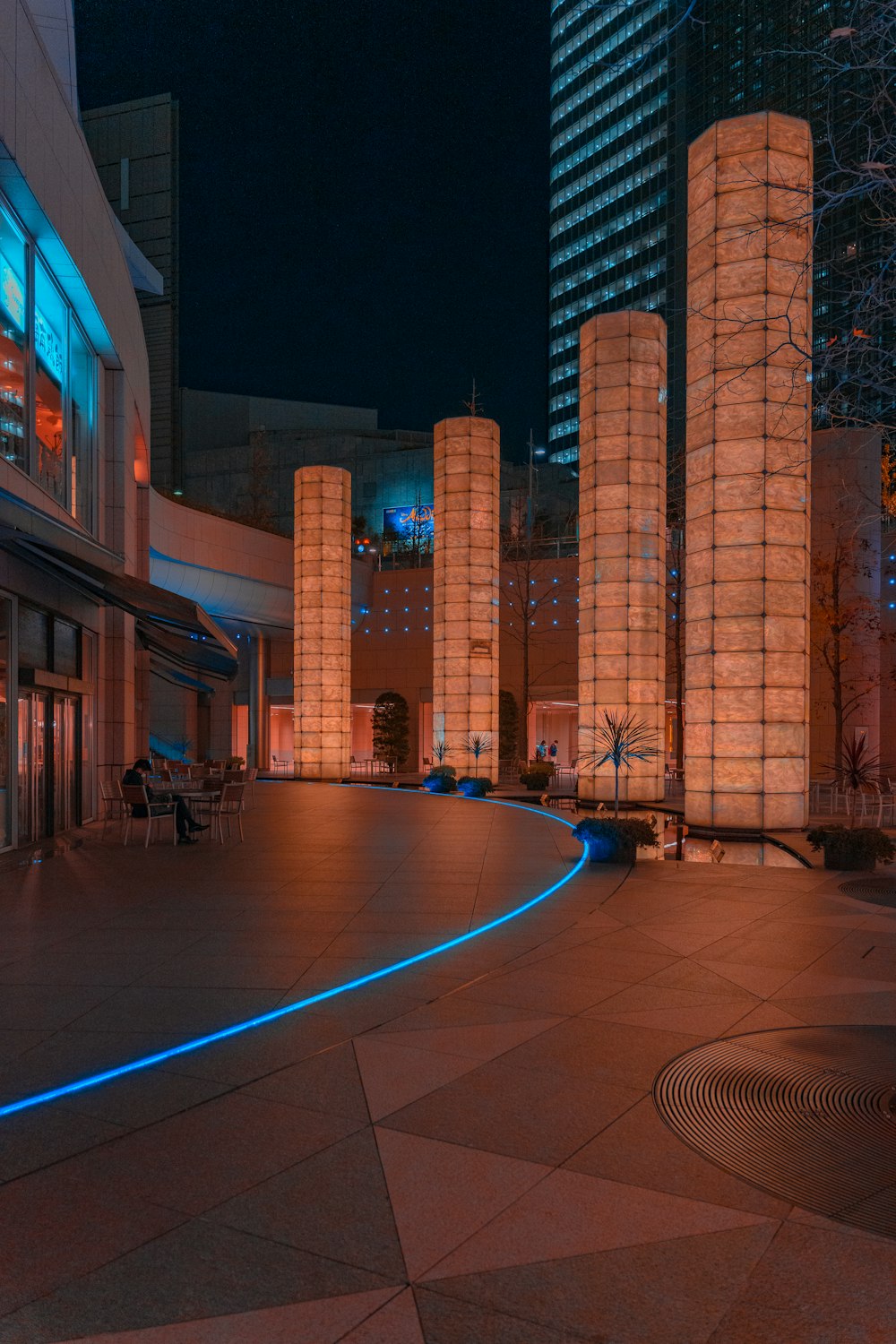 a city square with a clock tower lit up at night