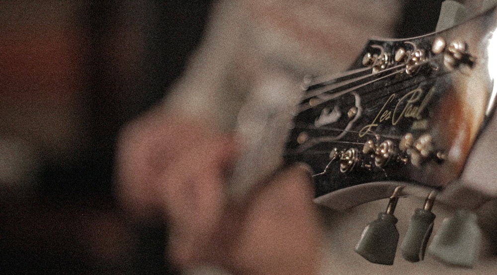 a close up of a person playing a guitar