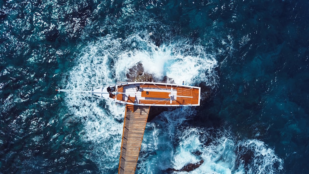 an aerial view of a boat in the ocean