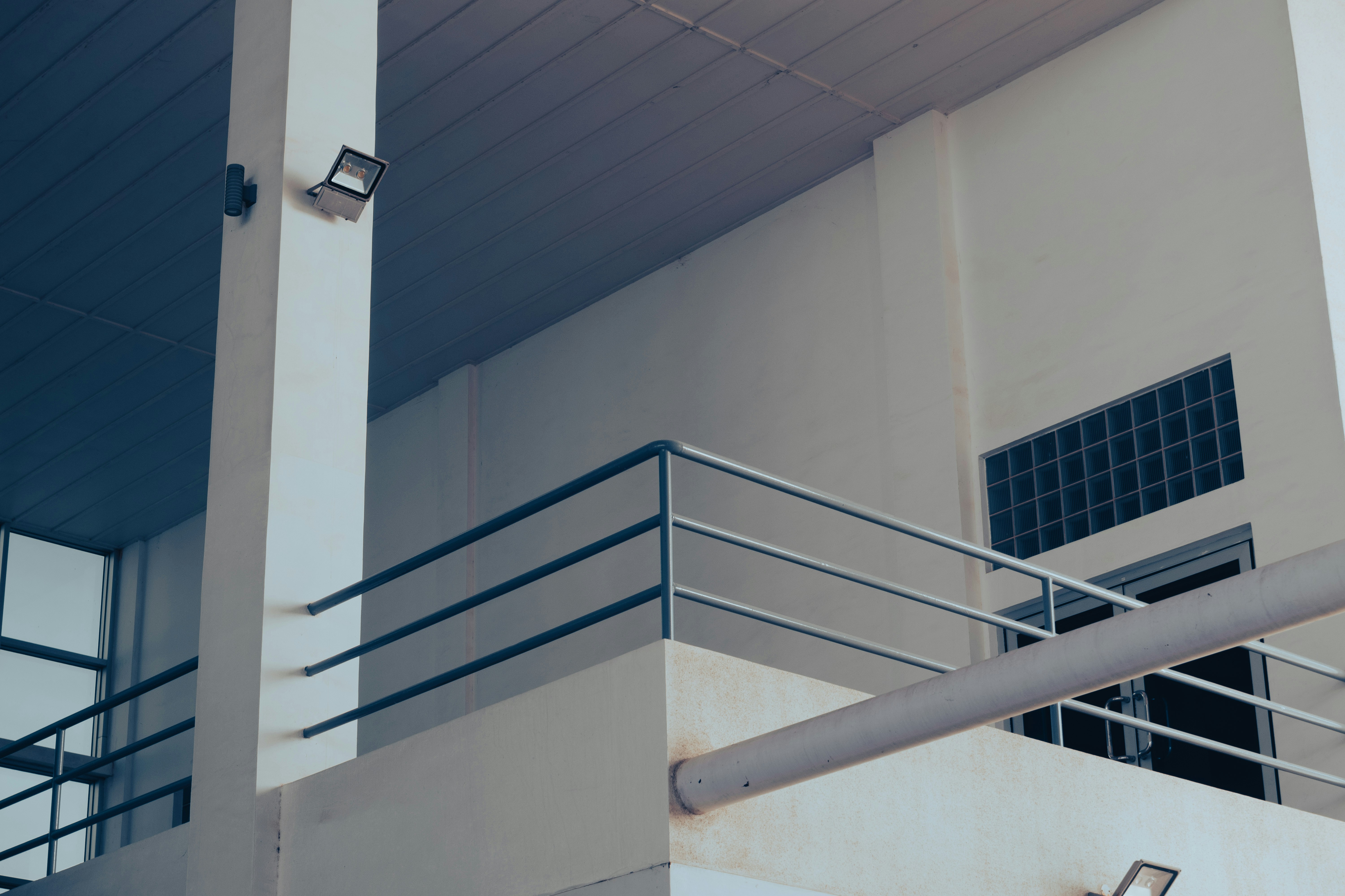 a white building with a metal hand rail