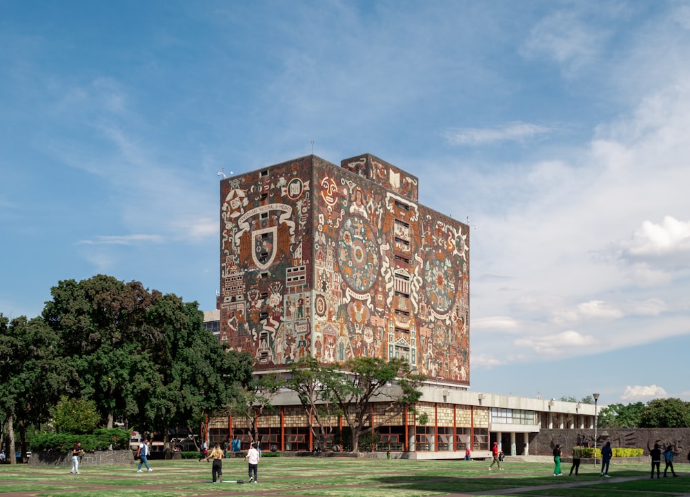 a tall building with a lot of people walking around it