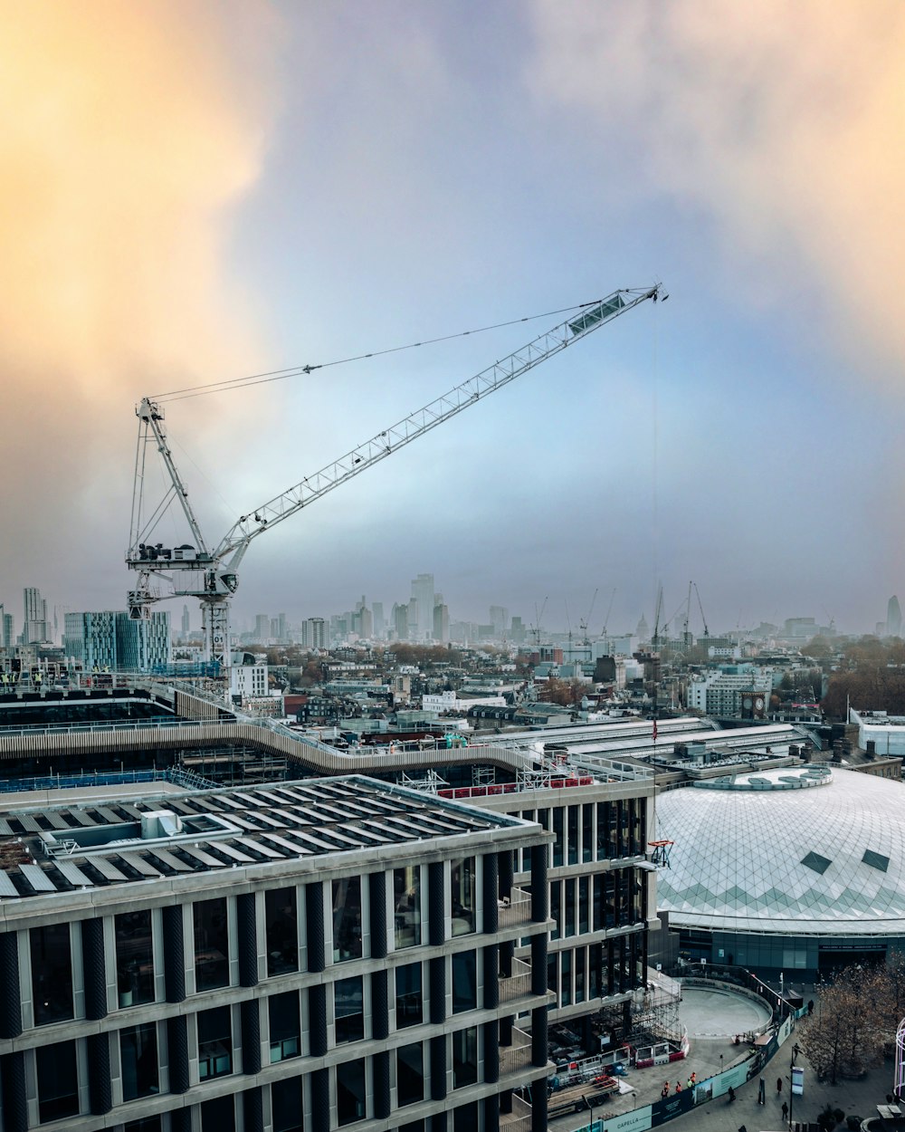 a crane is in the sky over a city