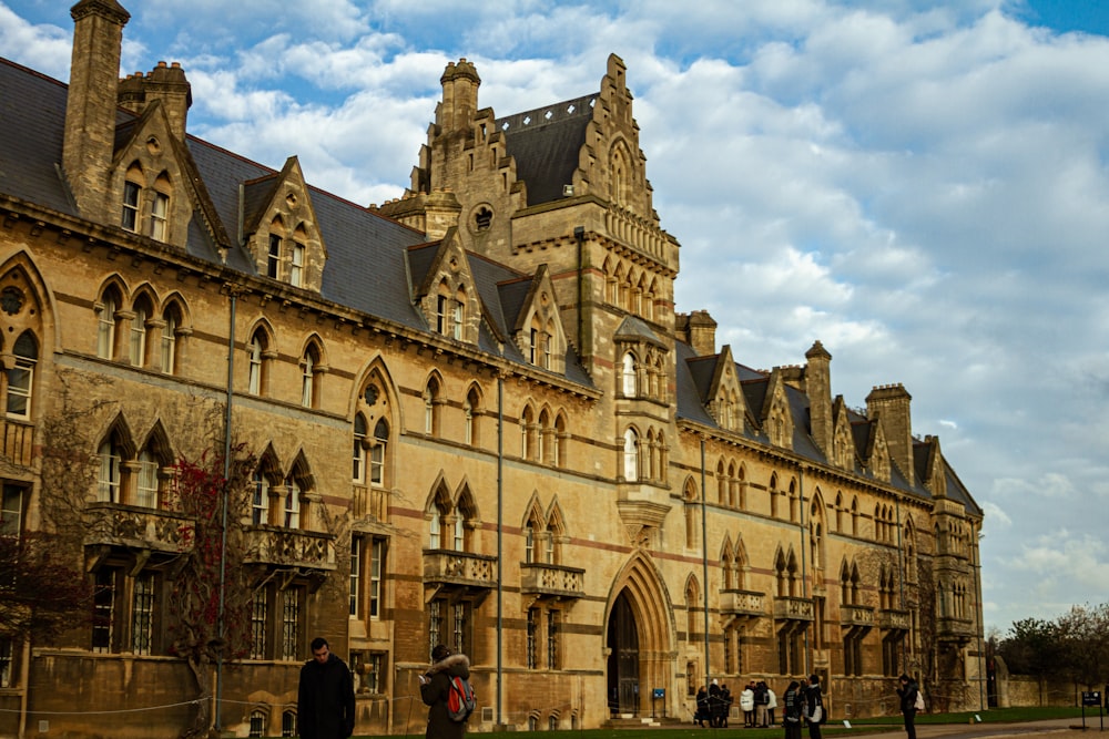 a group of people standing in front of a large building