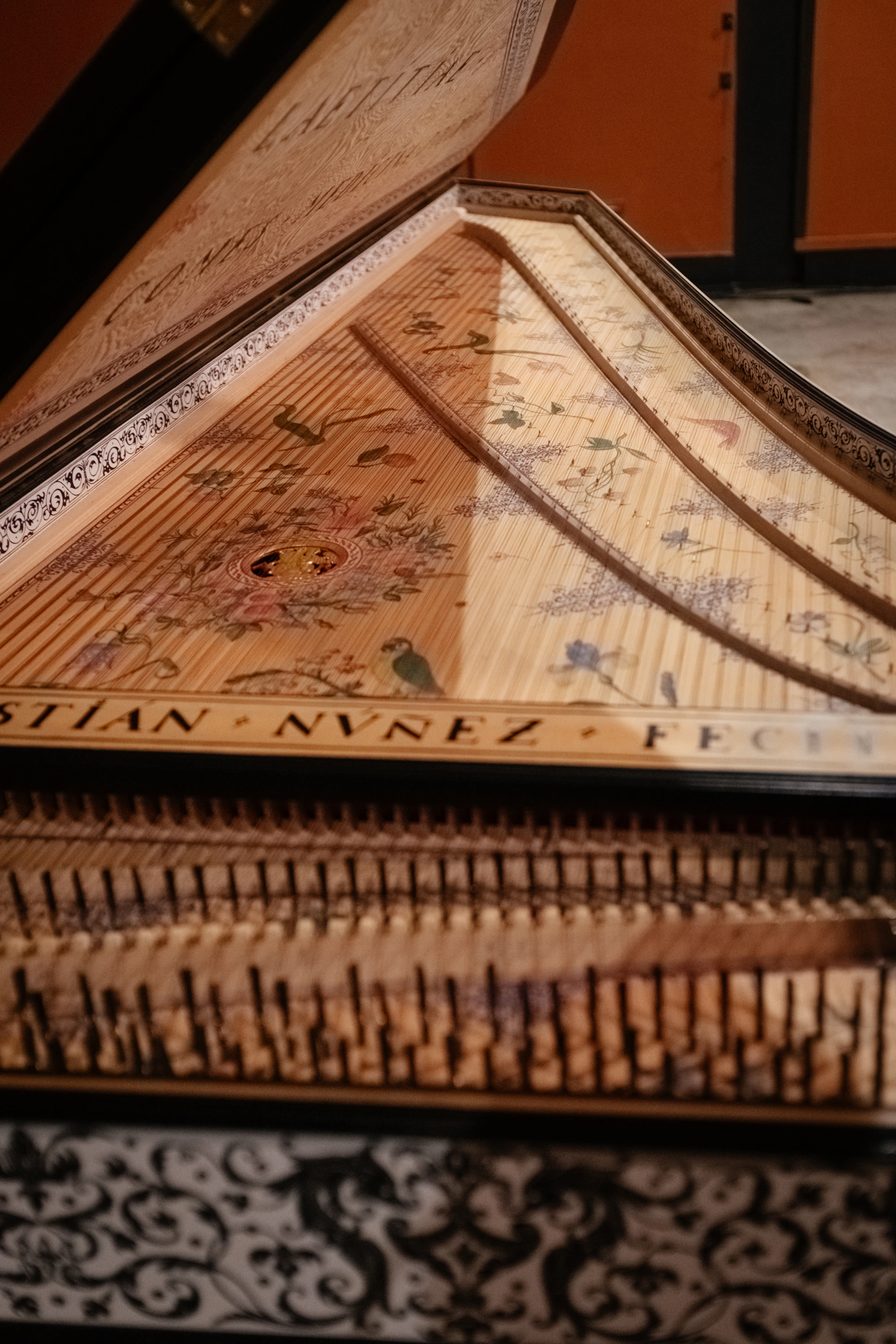 a close up of a piano with a wooden case