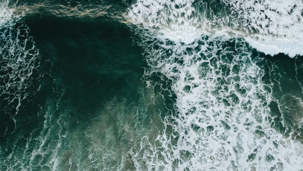 an aerial view of the ocean waves from above