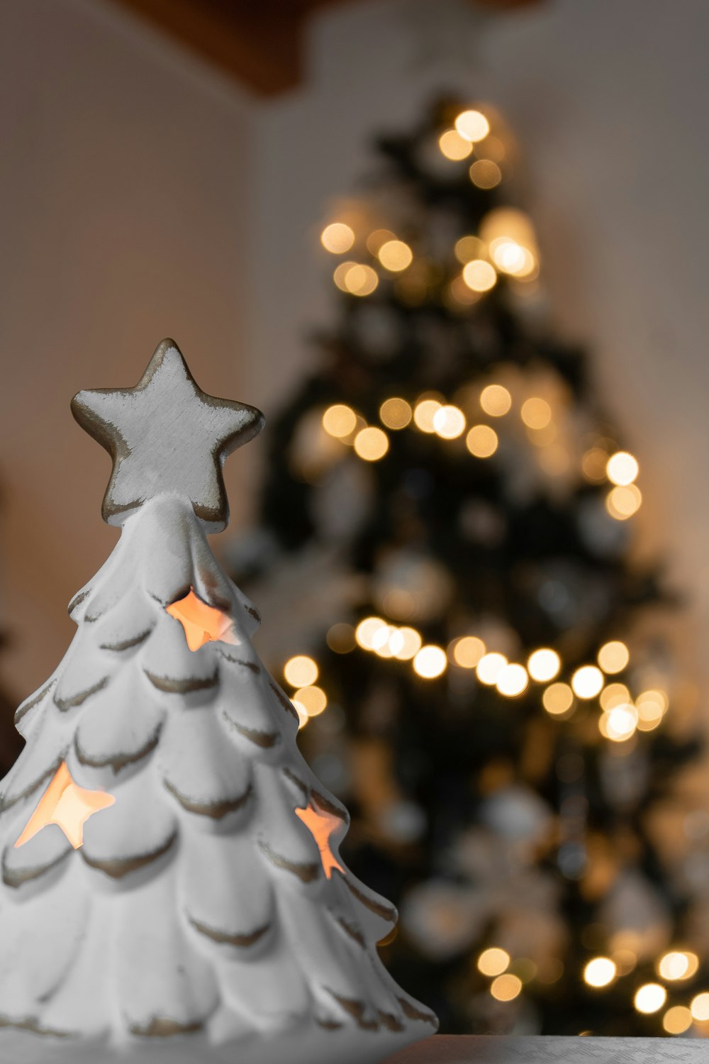 a small white christmas tree sitting on top of a table