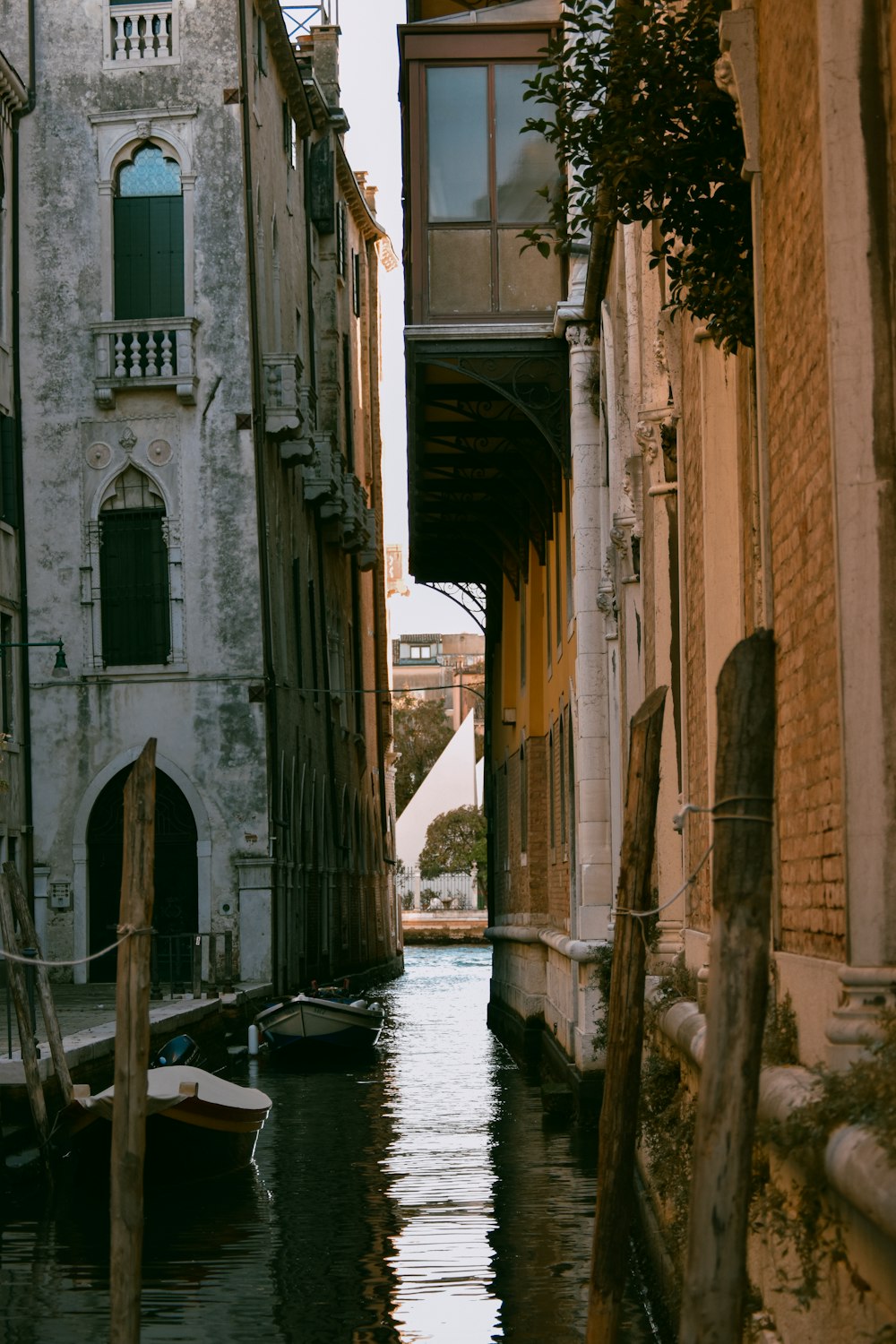 a narrow canal in a city with buildings on both sides