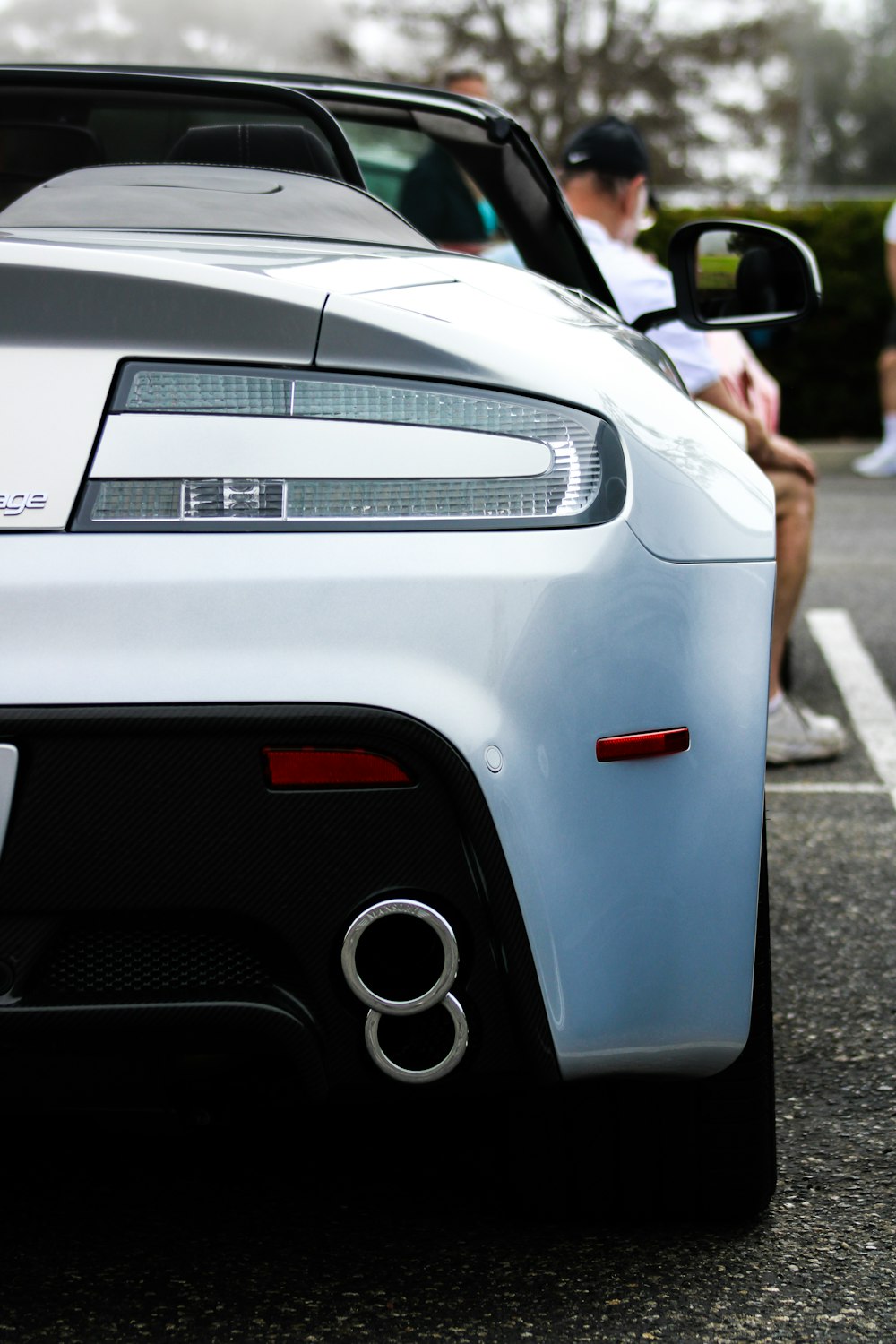 a white sports car parked in a parking lot