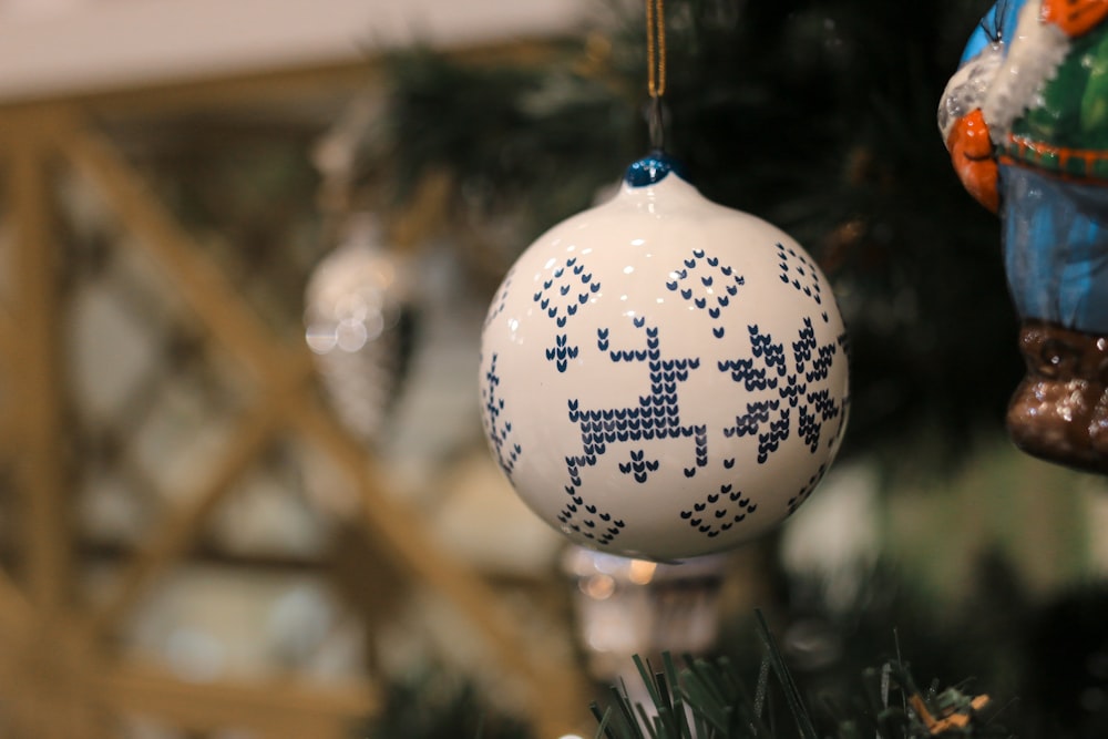 a white ornament hanging from a christmas tree