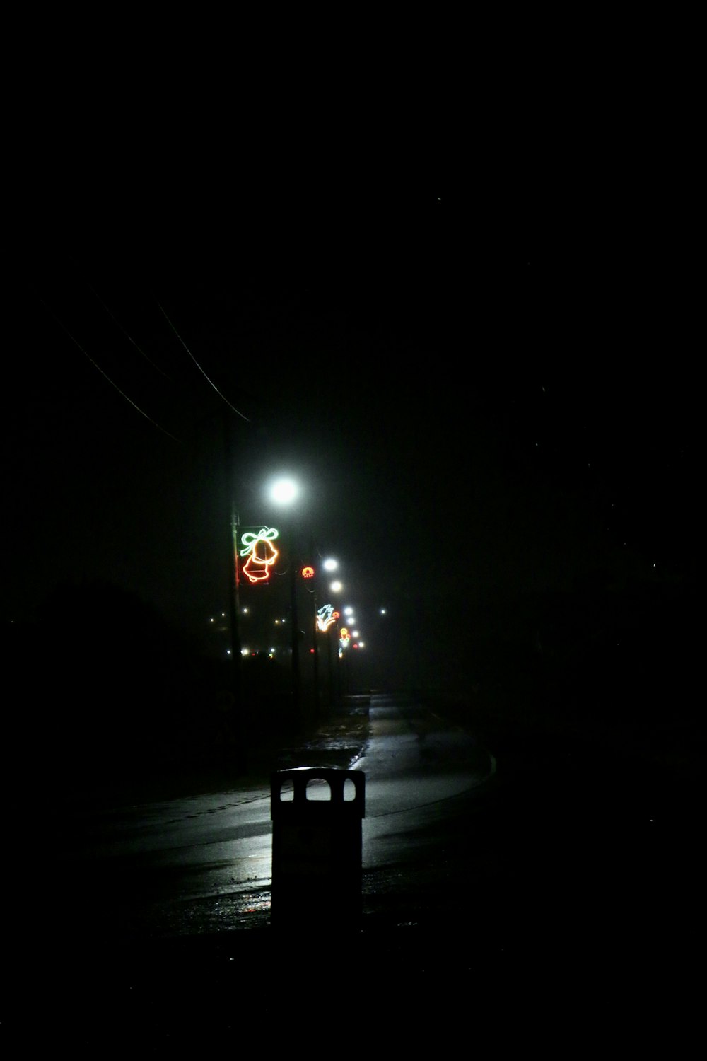 a street at night with a traffic light