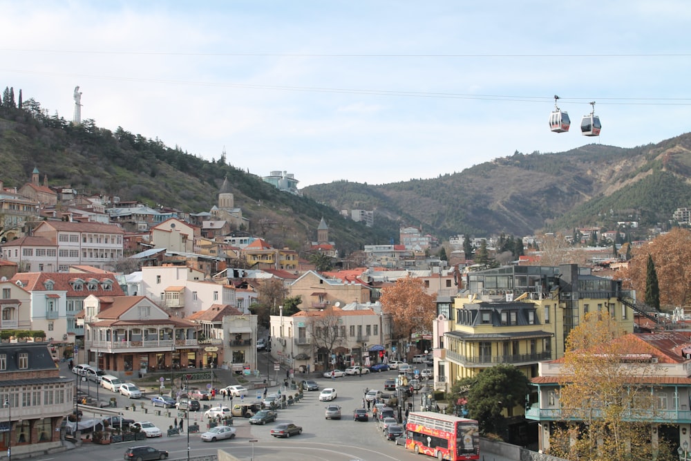 a city street with a cable car going over it