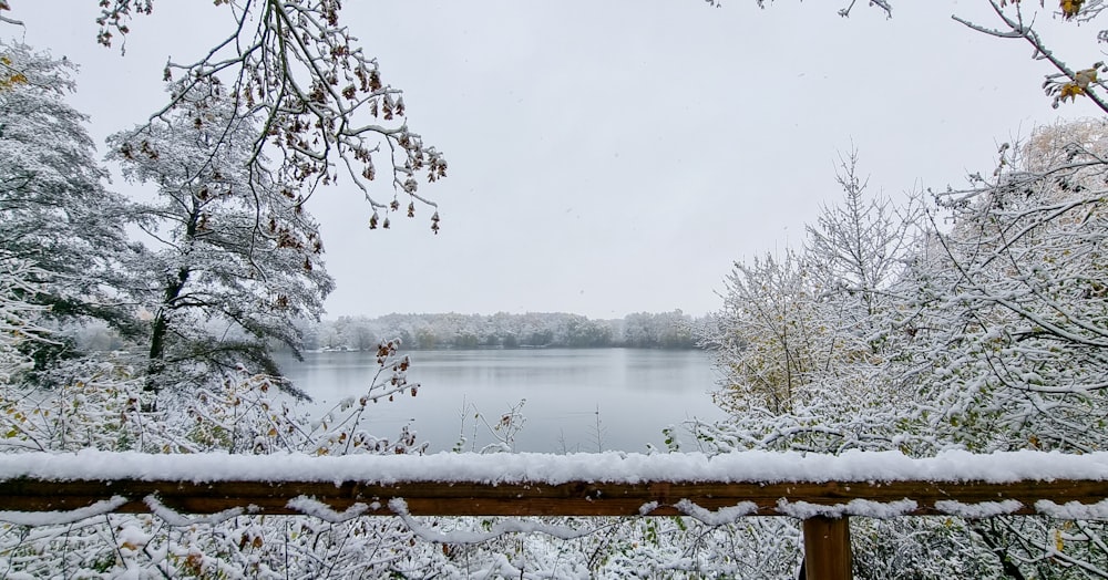 a snowy view of a lake from a deck