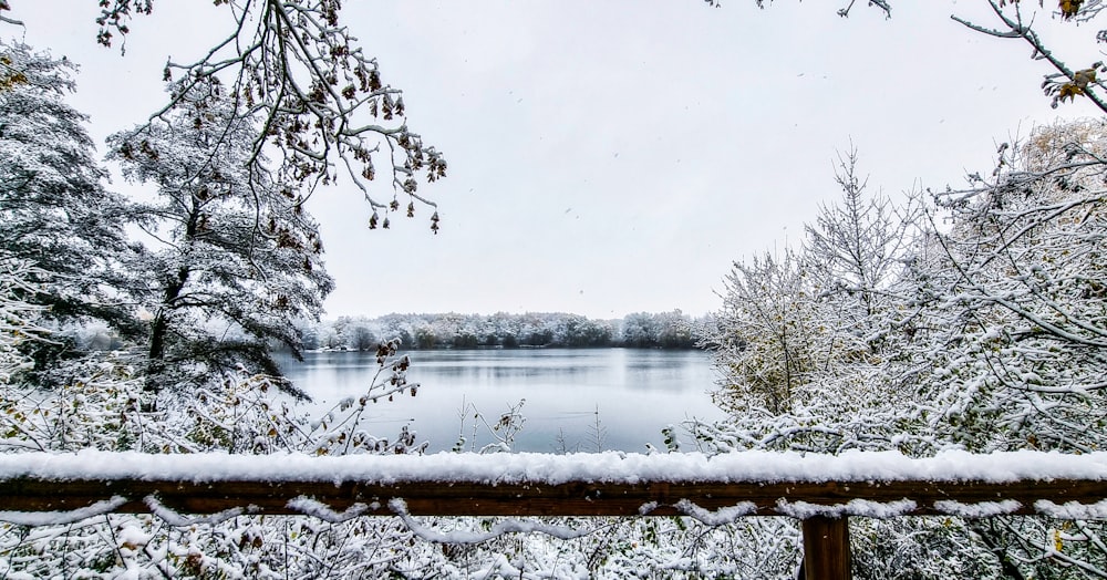 a snowy view of a lake from a deck