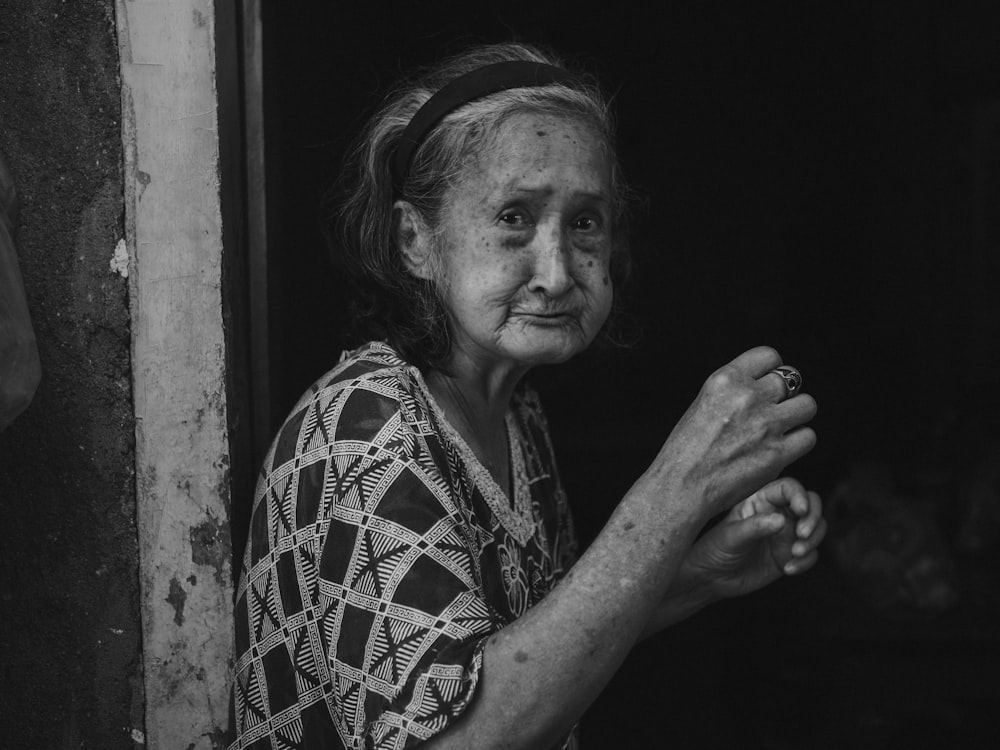 a black and white photo of a woman holding something