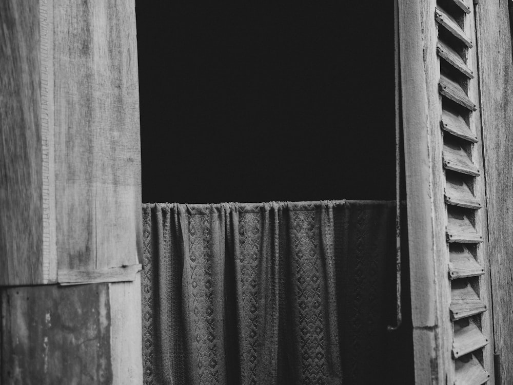 a black and white photo of an open window