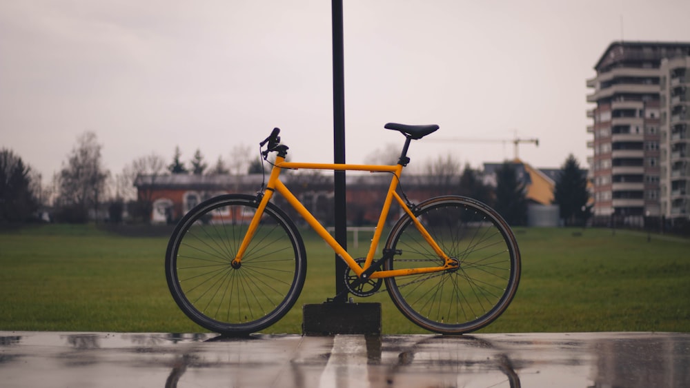 a yellow bicycle parked on the side of a road