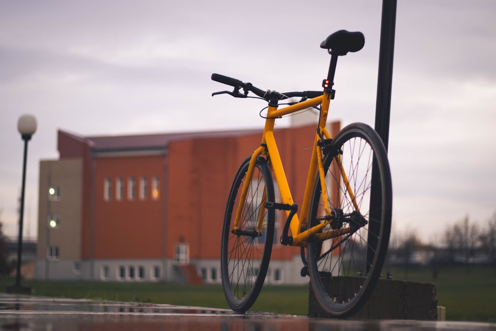 a yellow bicycle is parked in front of a building