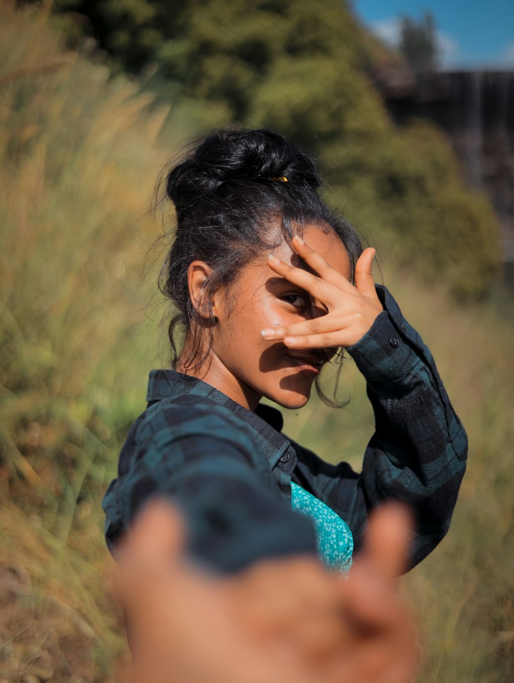 a woman holding her hand up to her face