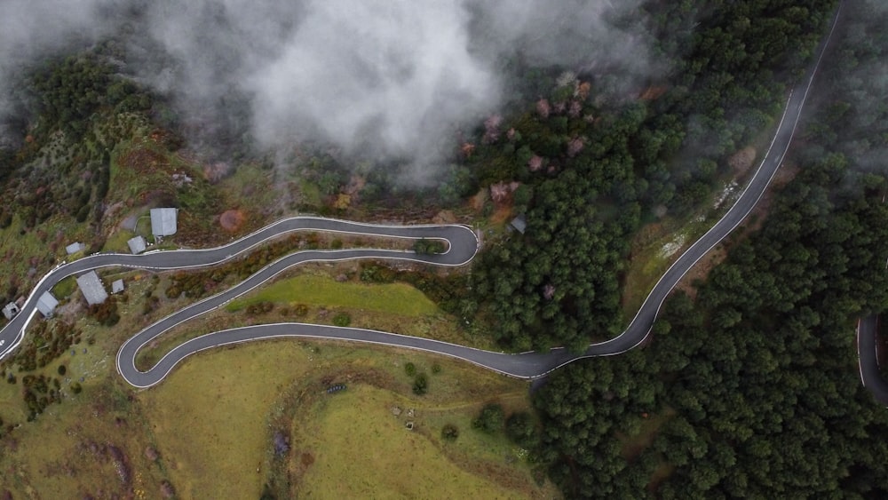 an aerial view of a winding road in the mountains