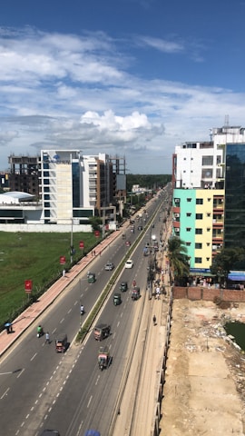 A wide-angle shot of the massive Dodbalapur main road turf bustling with weekend players.