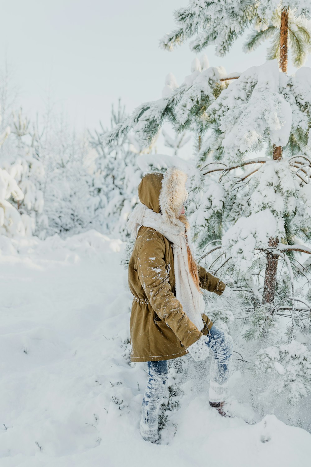 a person walking through the snow in the woods