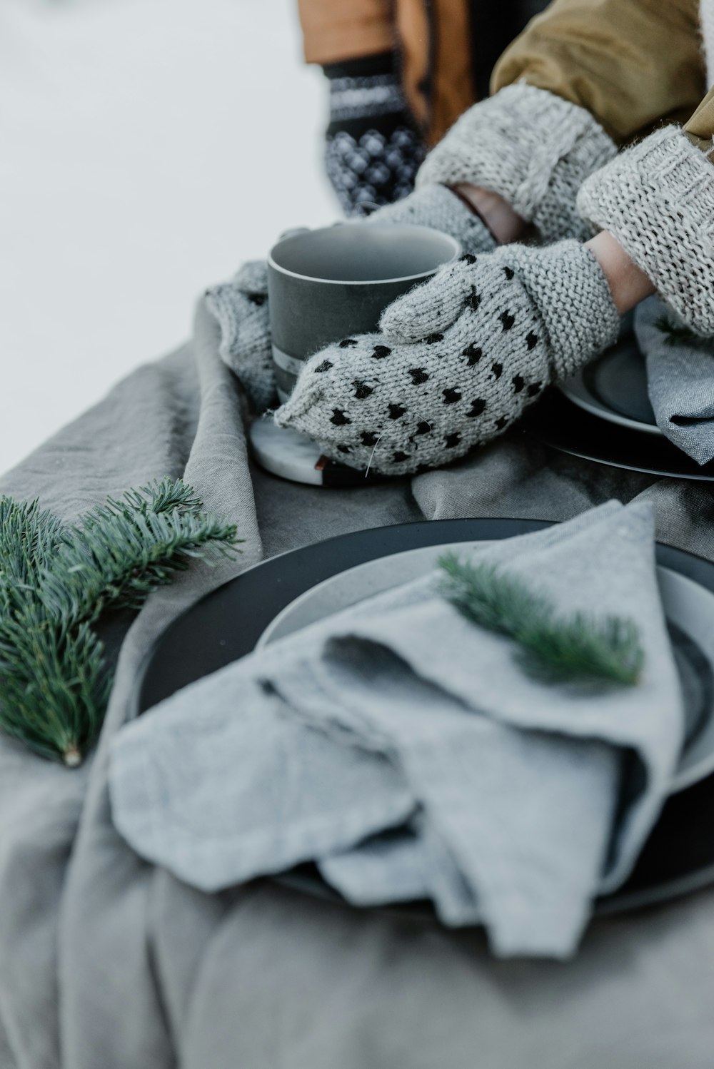 a table topped with a plate and a cup of coffee