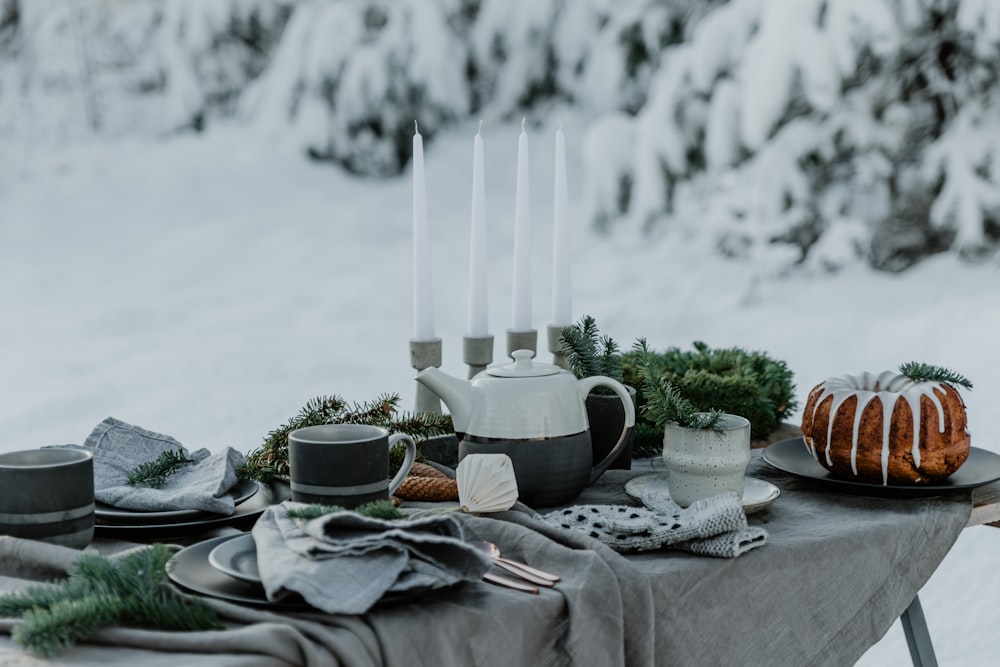 a table topped with a cake covered in frost