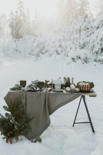 a table with a cloth on it in the snow