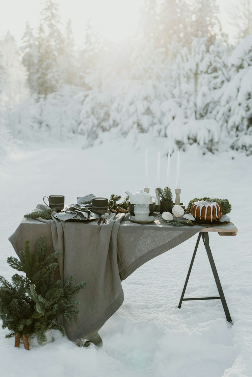 a table with a cloth on it in the snow